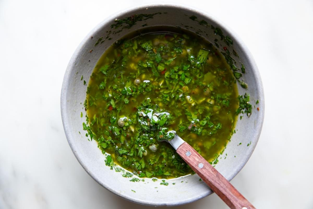 A small bowl of Italian salsa verde with a spoon