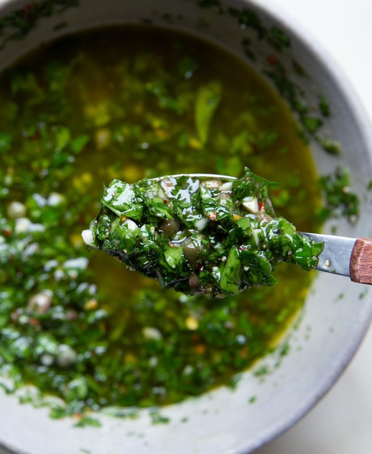 Italian Salsa verde on a spoon over a bowl