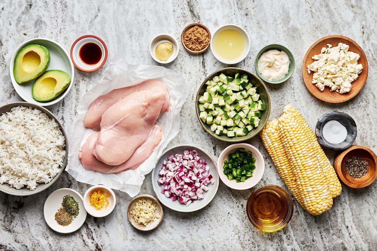 chicken breast, zucchini, corn, avocado, garlic, rice, onion, spices for grilled chicken bowl in prep bowls