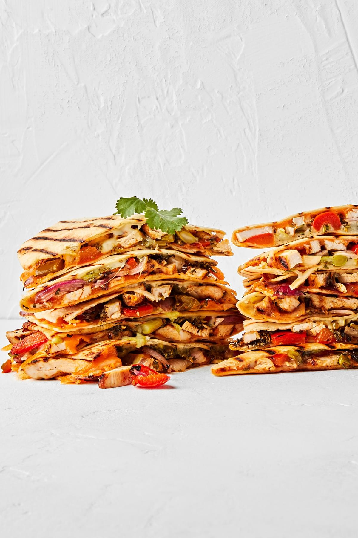 grilled chicken quesadillas sliced and stacked on top of each other