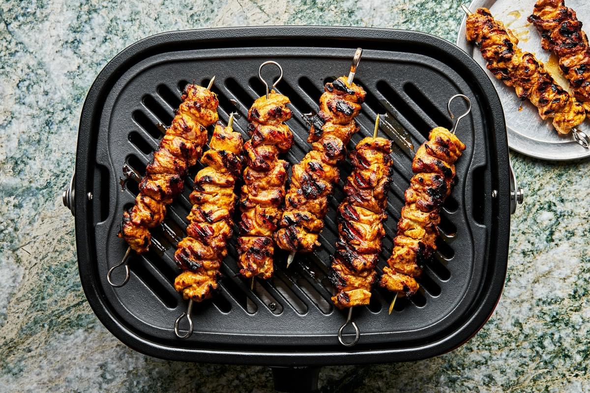 chicken shawarma kebabs cooking on a grill