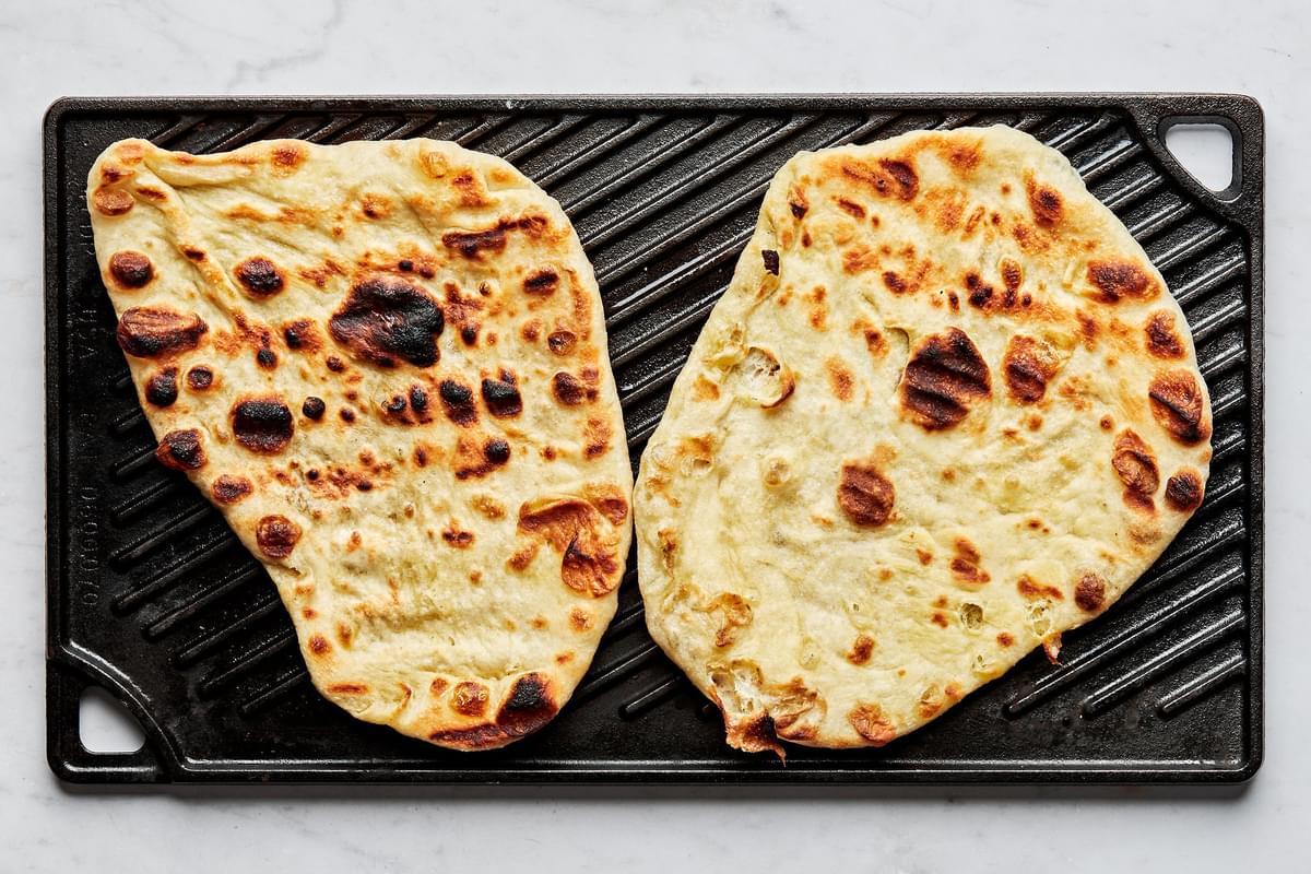 flat bread brushed with olive oil being grilled