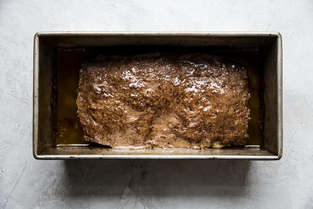 Homemade baked gyro meat in a loaf pan made with ground beef, ground lamb, minced onion and spices