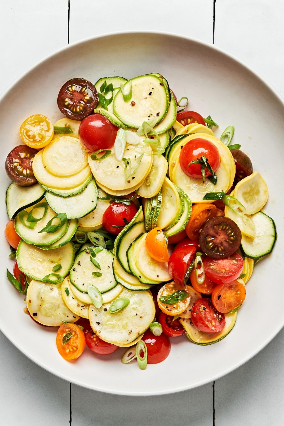 zucchini, squash, tomatoes, and green onions tossed with olive oil, lemon zest, lemon juice, honey, salt, and pepper
