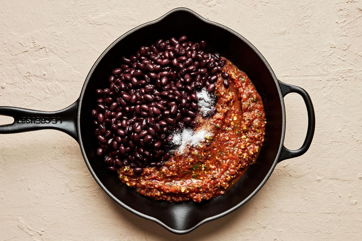 black beans and salsa simmering together in a skillet