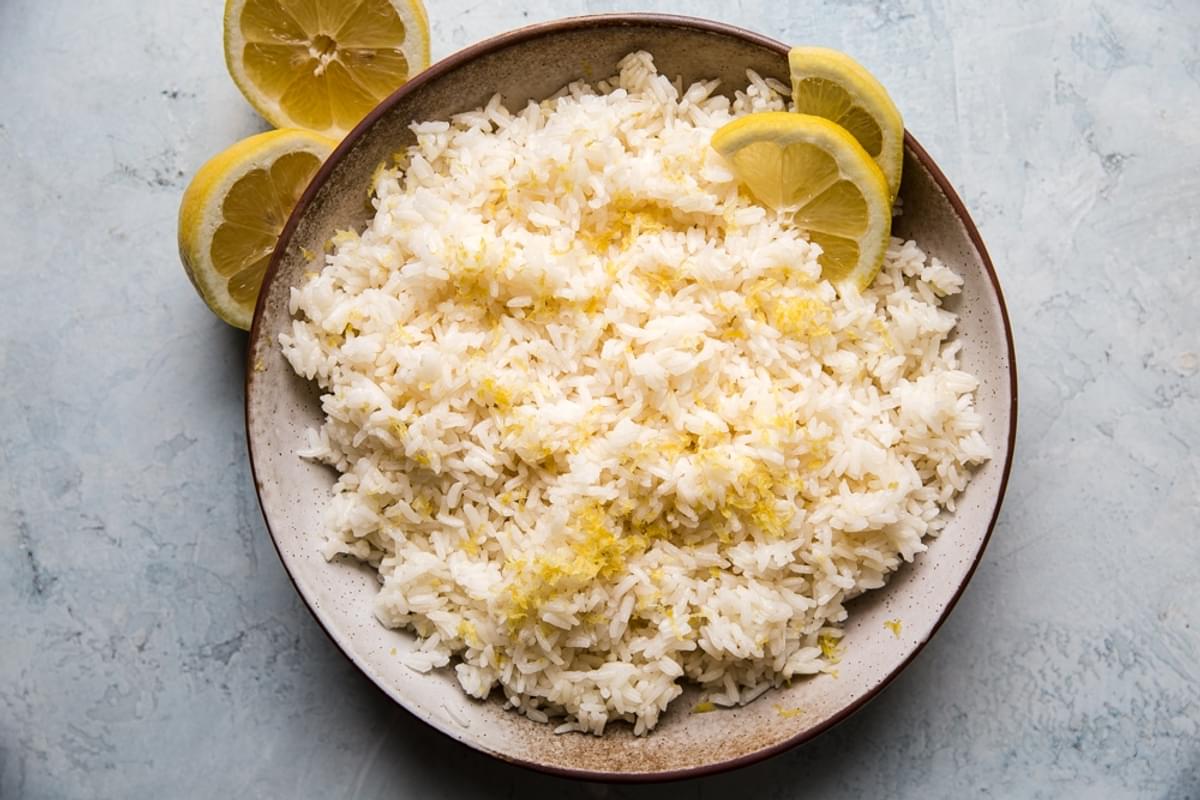 lemon rice in a bowl with lemon zest and lemon slices
