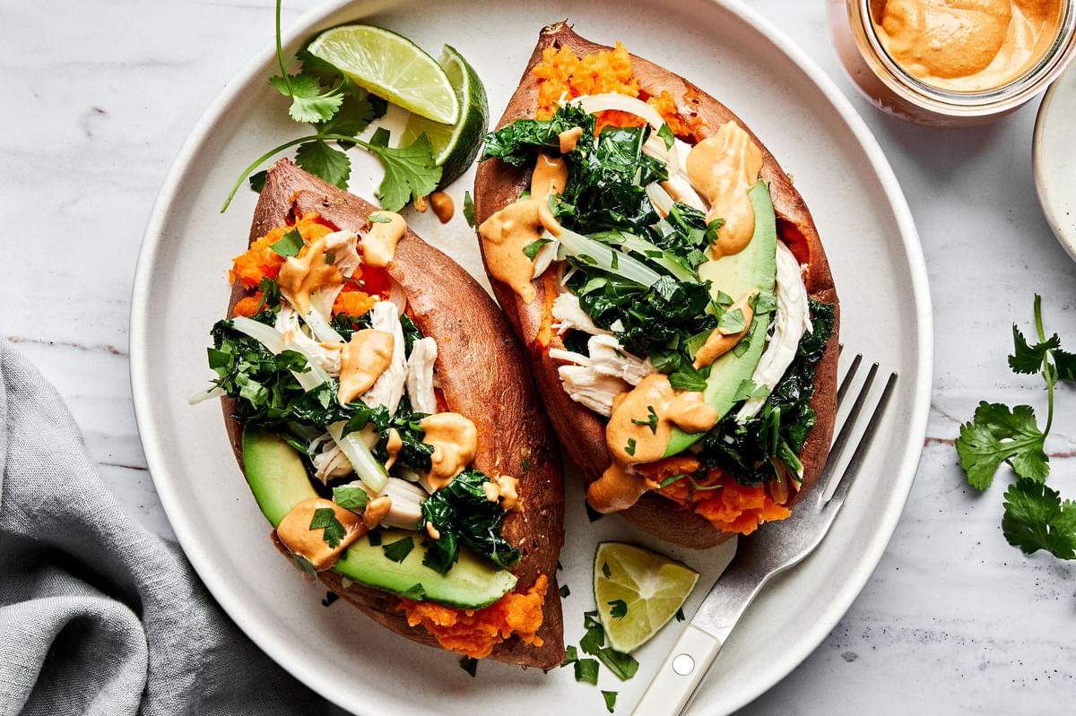 baked sweet potatoes loaded with sautéed kale and onions, chicken, avocado, chipotle cashew cream sauce & cilantro