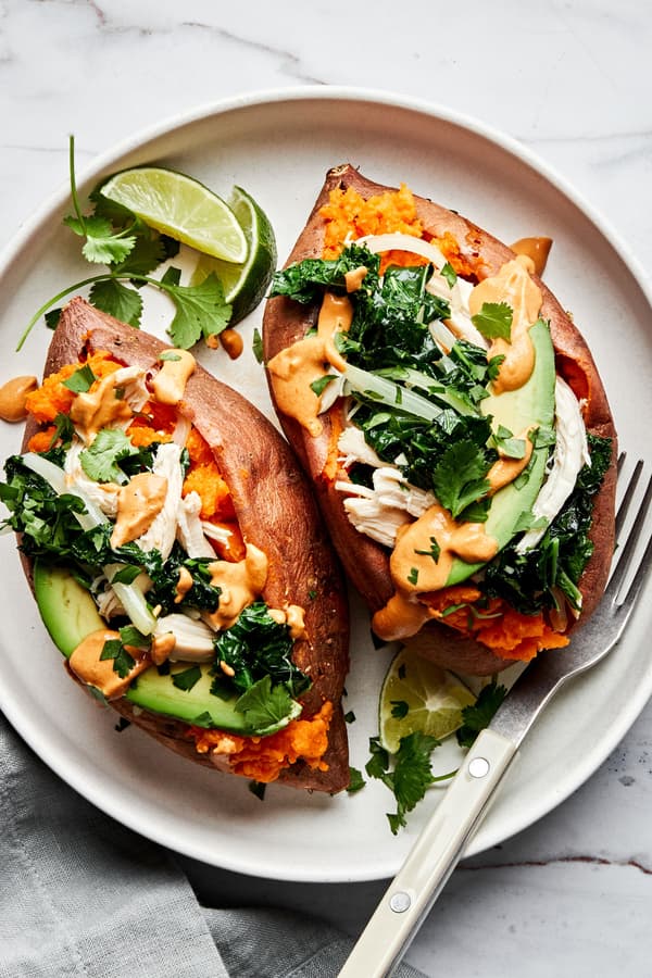 baked sweet potatoes loaded with sautéed kale and onions, chicken, avocado, chipotle cashew cream sauce & cilantro