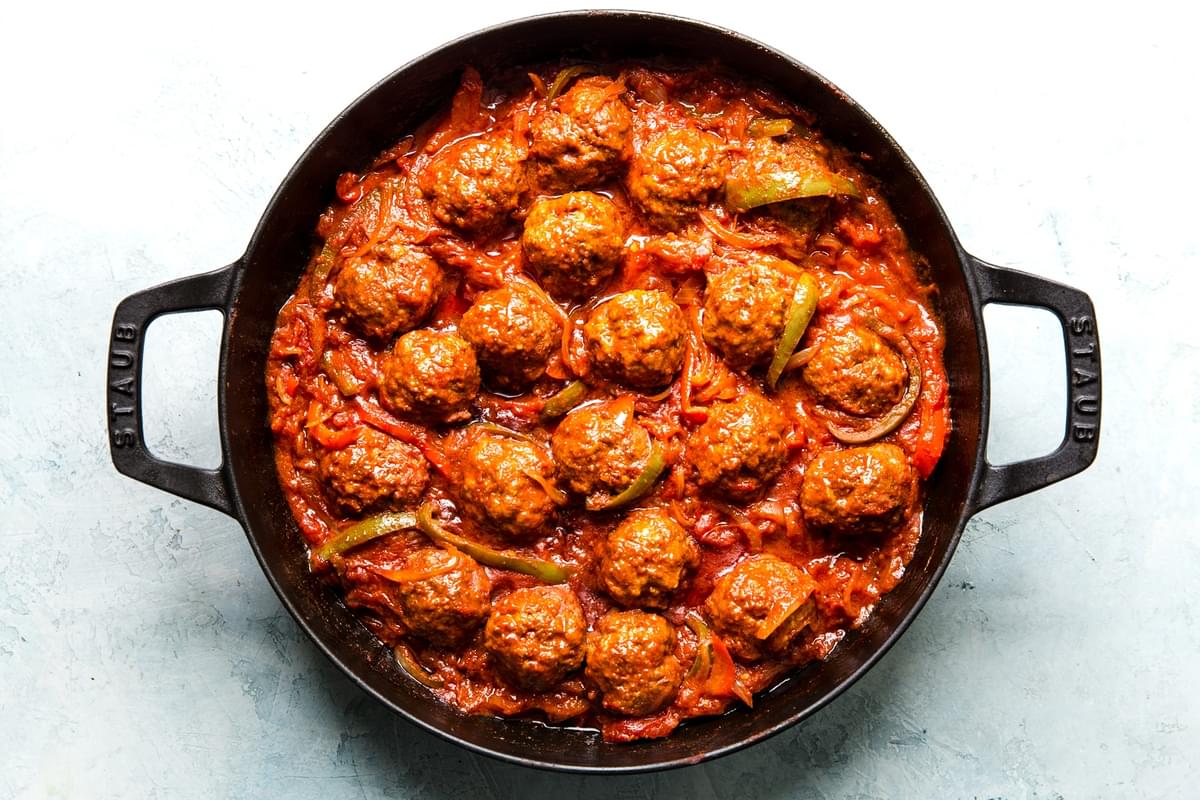 baked meatballs in a shakshuka tomato sauce in a skillet