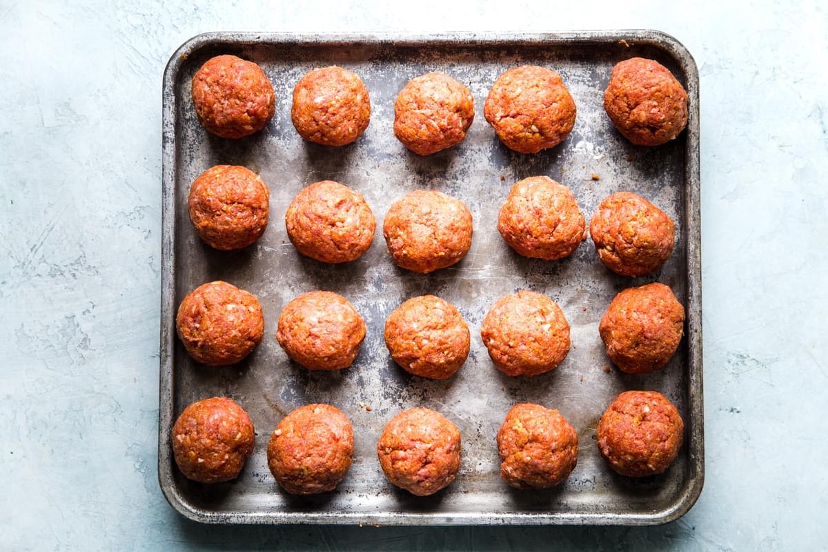 20 raw meatballs on a sheet pan