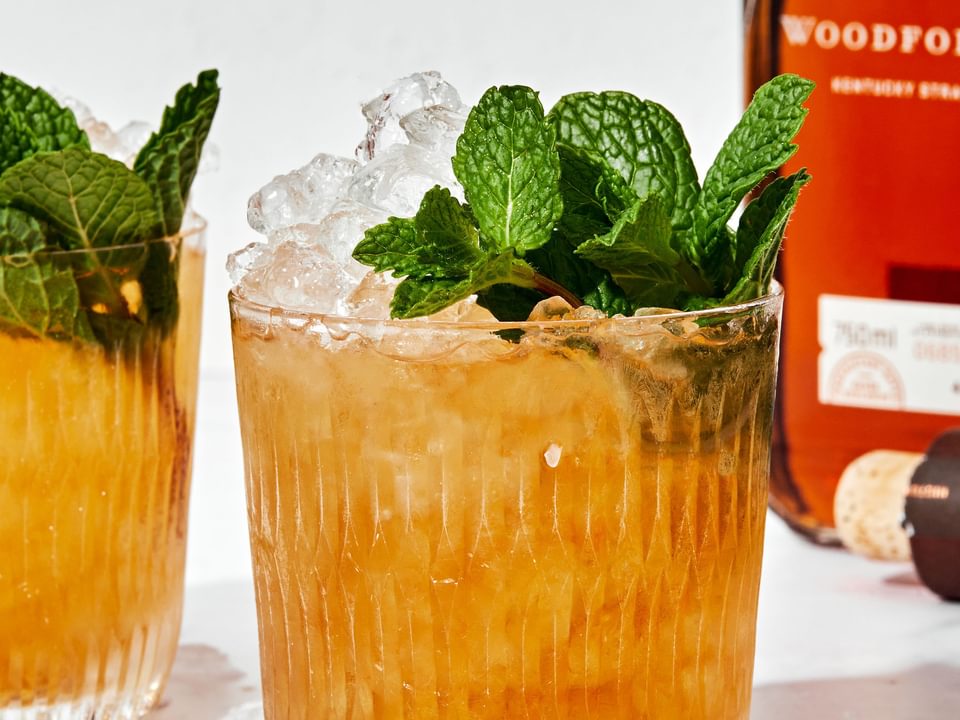 homemade mint julep in a glass made with fresh mint, bourbon and simple syrup served over crushed ice with fresh mint leaves