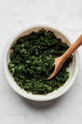 homemade mint sauce in a bowl with a small wooden spoon