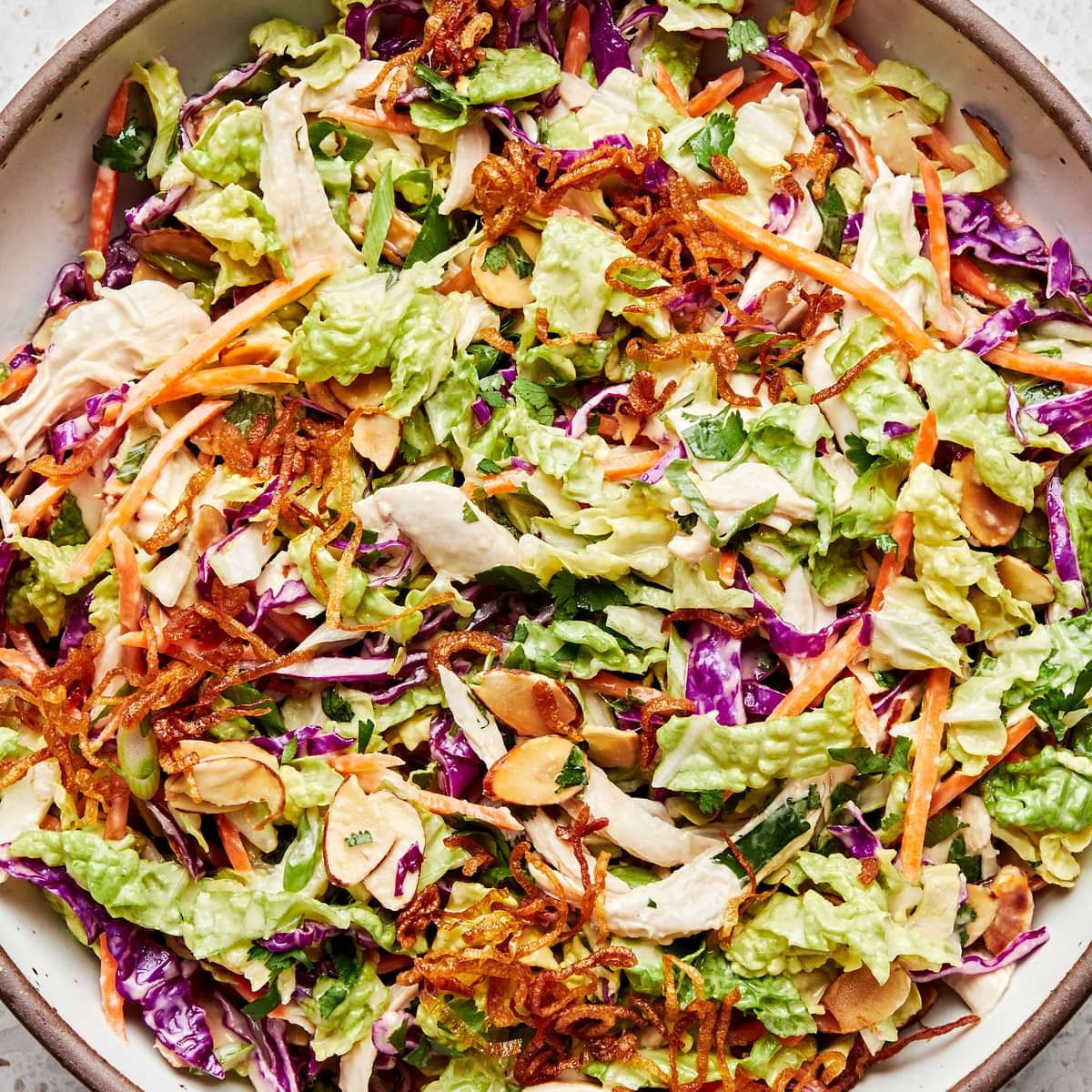miso-ginger chicken slaw made with cabbage, almonds, cilantro, carrots, green onion, sesame oil, vinegar and spices