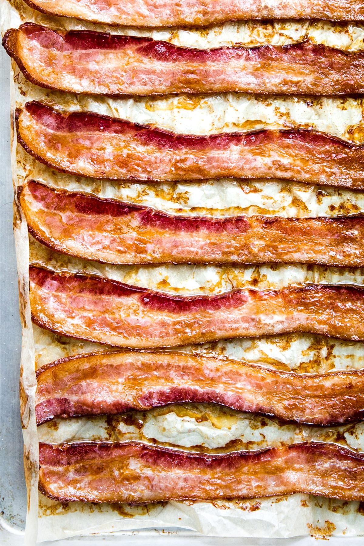 8 slices of bacon cooked in the oven on a parchment paper lined baking sheet