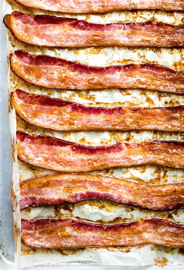 8 slices of bacon cooked in the oven on a parchment paper lined baking sheet