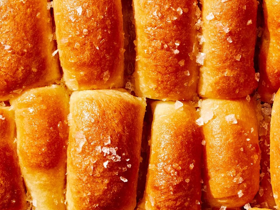 homemade parker house rolls brushed with butter and sprinkled with flaky salt