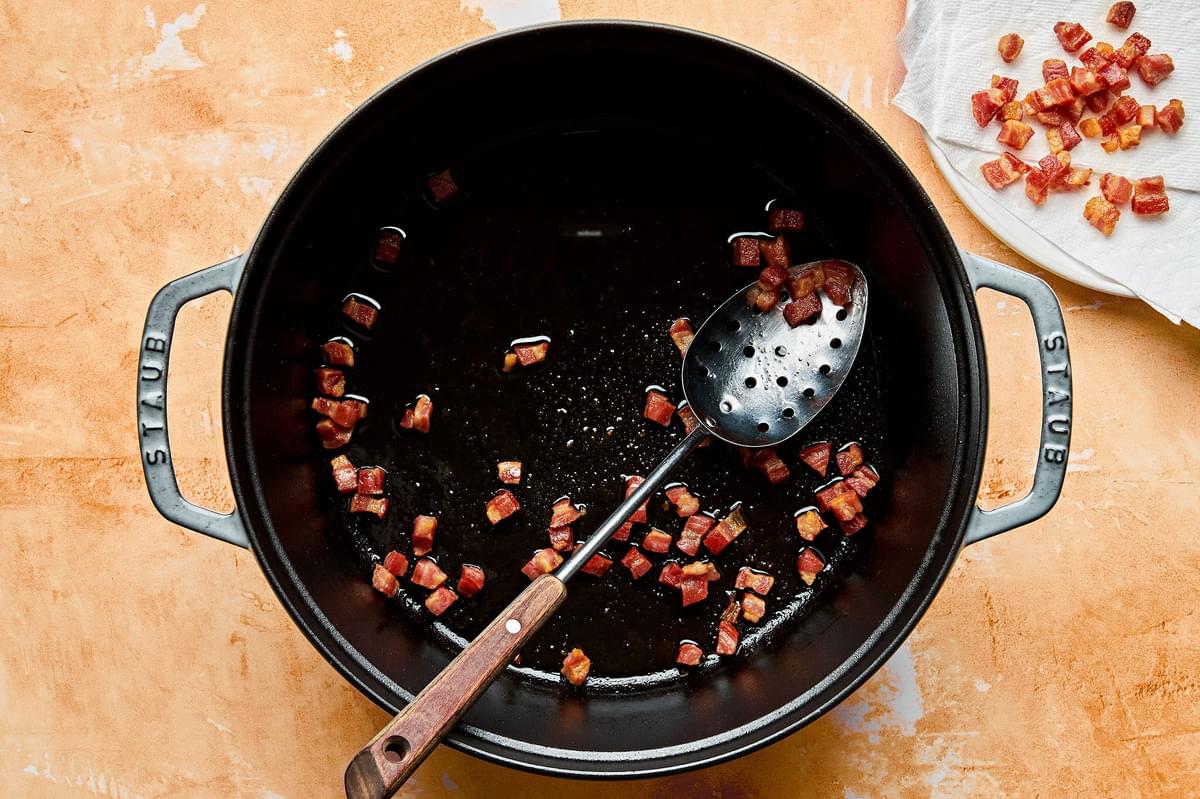 diced pancetta being cooked in a pot