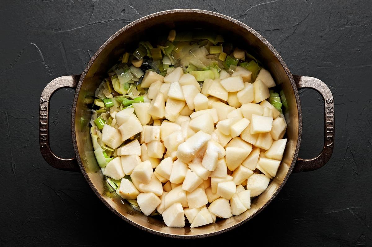 shallots, leeks, butter, oil, garlic, pears and salt cooking in a pot