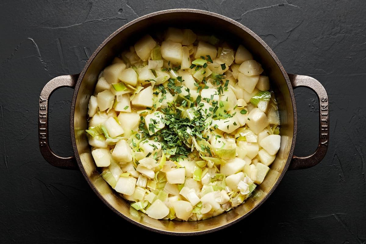 shallots, leeks, butter, oil, garlic, pears, salt and tarragon cooking in a pot