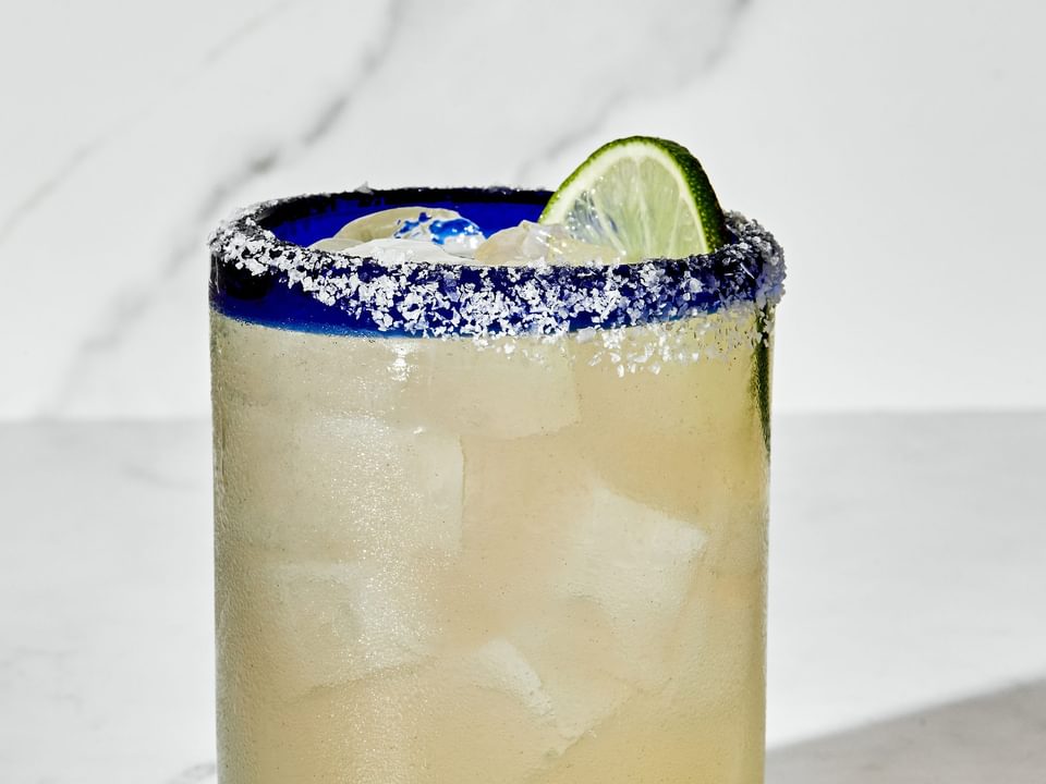 a margarita made with tequila, orange liqueur, lime juice and angostura bitters served with a salt rim and a lime wedge