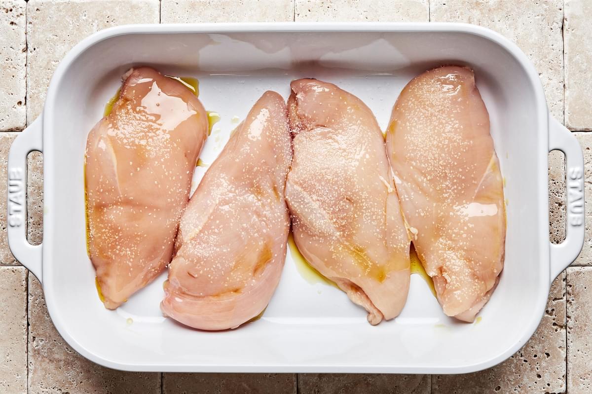 chicken brushed with olive oil and seasoned with salt in a baking dish