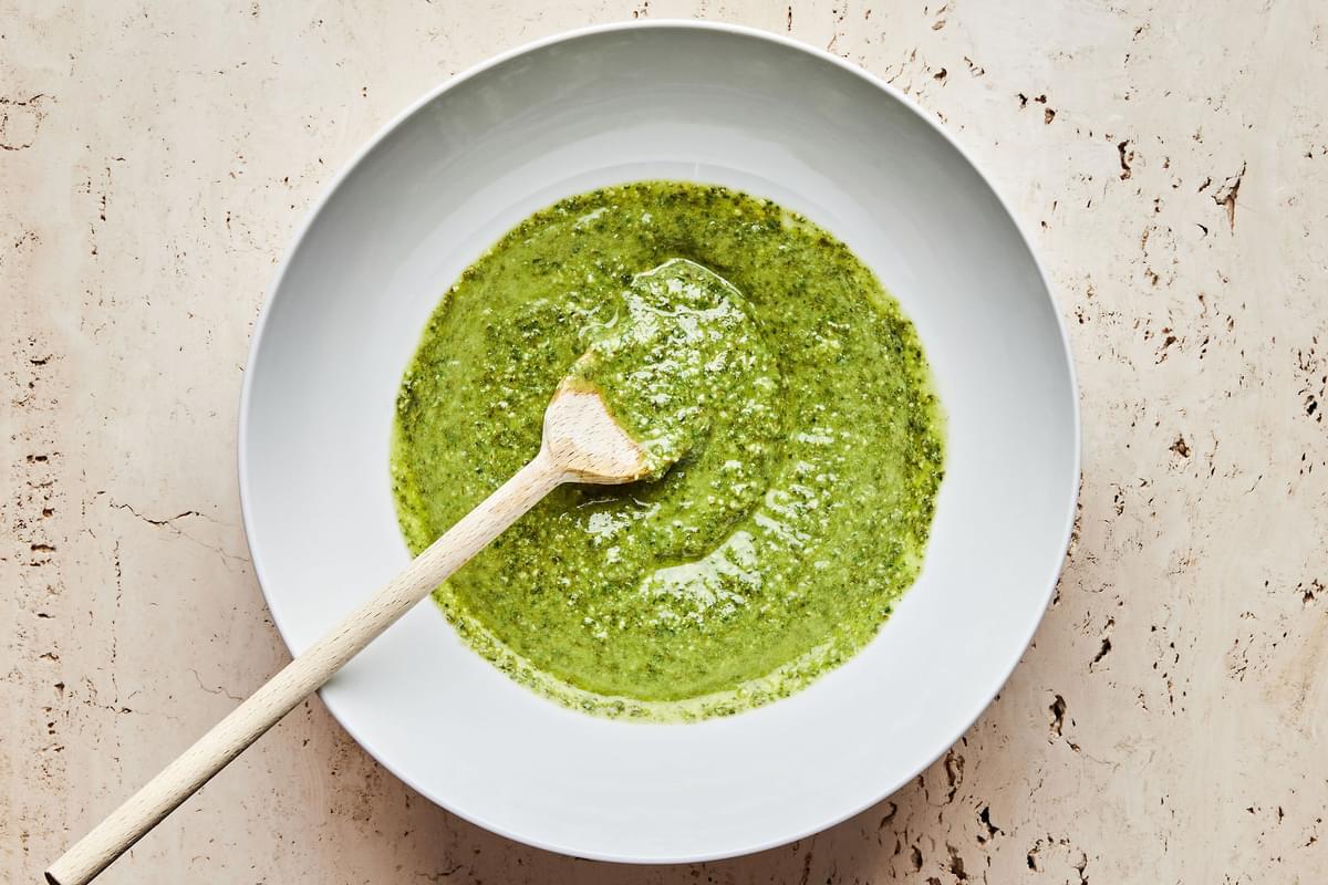 pesto sauce in a bowl with a spoon