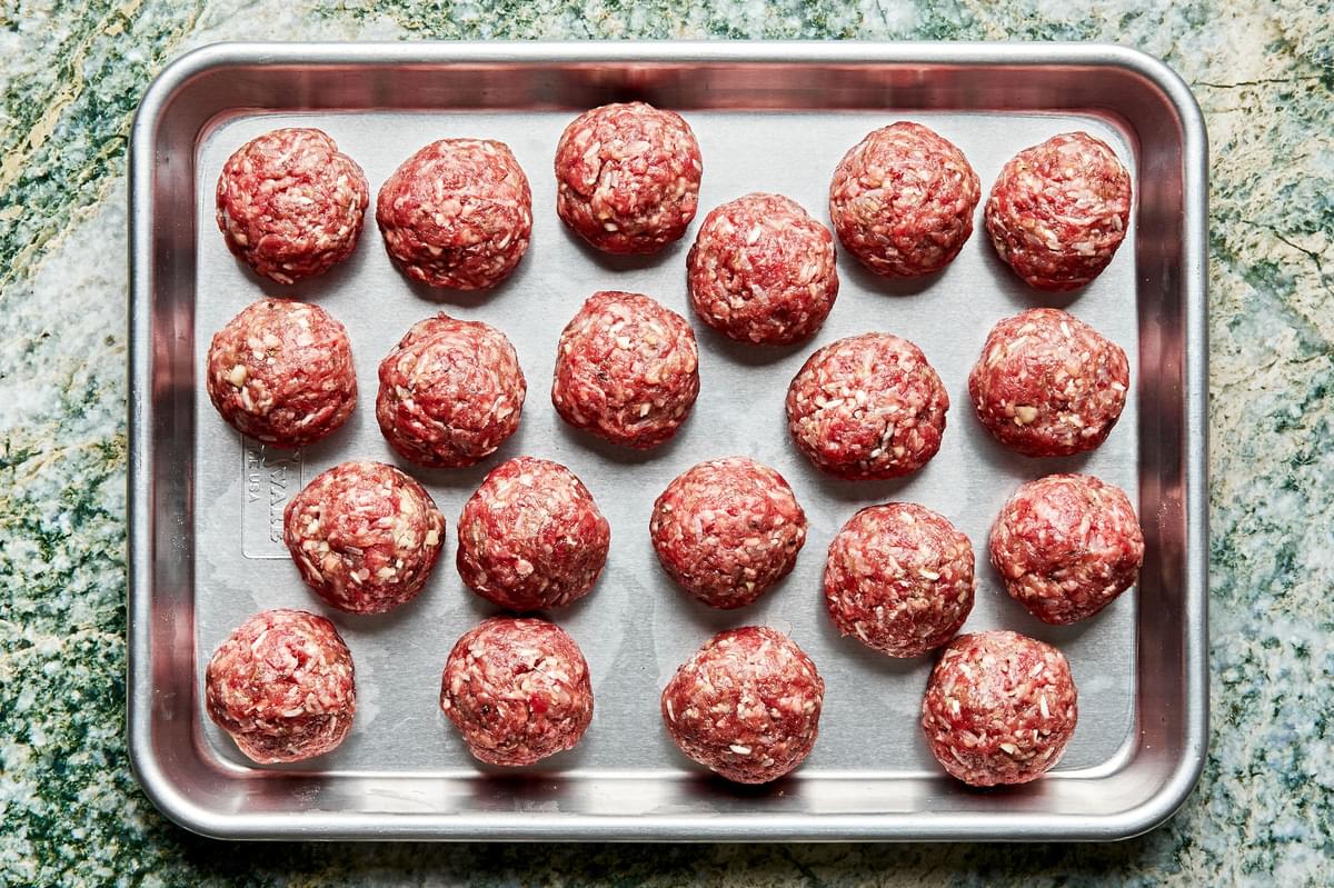 raw porcupine meatballs on a baking sheet