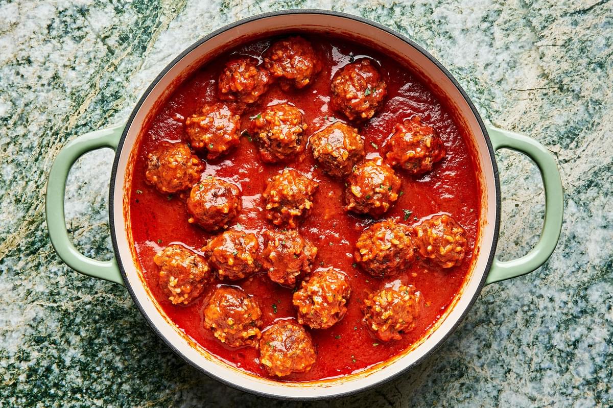 homemade meatballs cooking in homemade tomato sauce