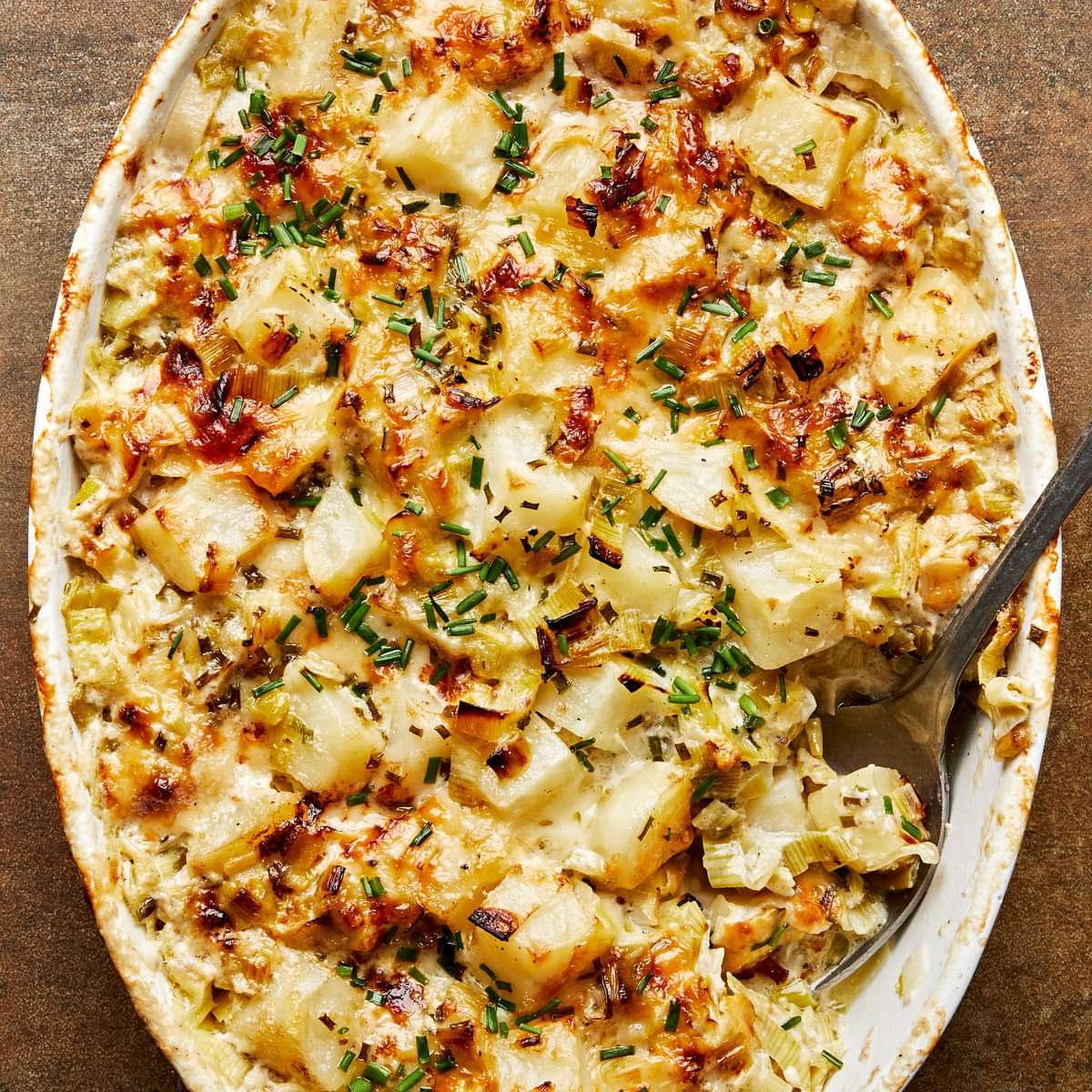 potato leek au gratin made with gruyère, parmesan, blue cheese, butter, cream, spices and ground mustard topped with chives