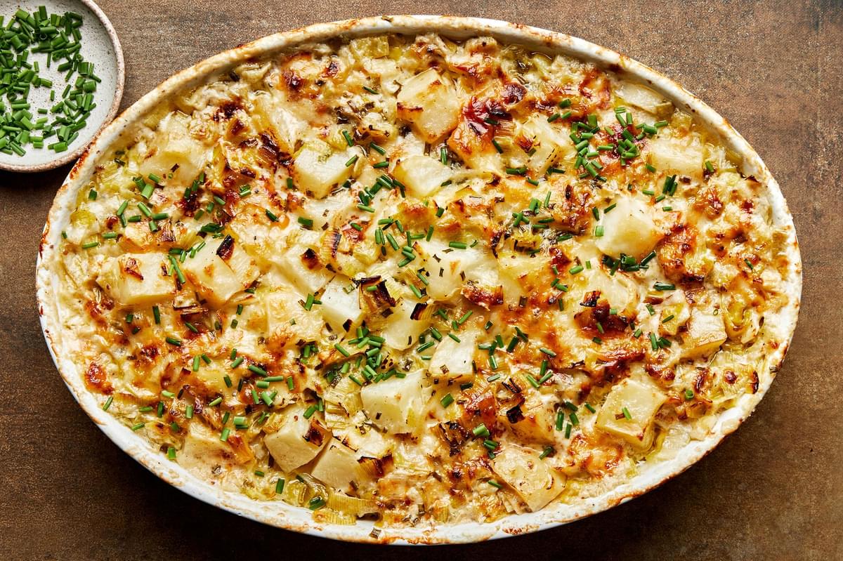 potato leek au gratin made with Gruyère, parmesan, blue cheese, butter, cream, spices and ground mustard topped with chives