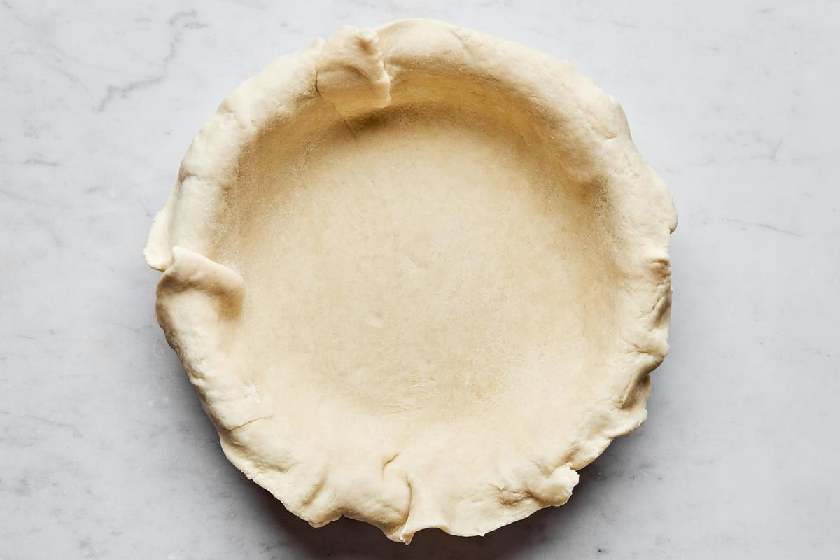 raw pie crust laid in a 9 inch deep dish pie plate