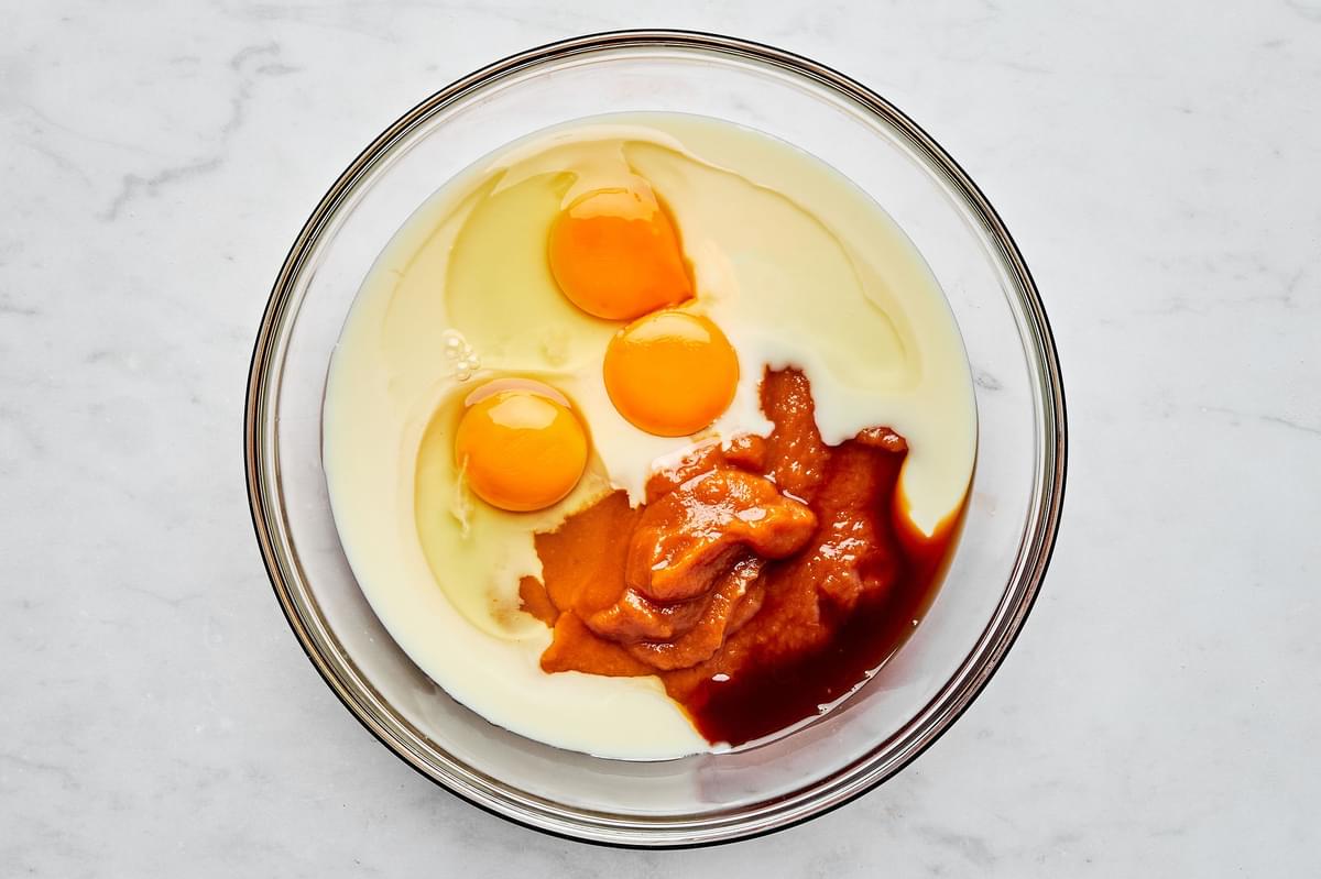 pumpkin, condensed milk, eggs, egg yolk and vanilla in a glass mixing bowl