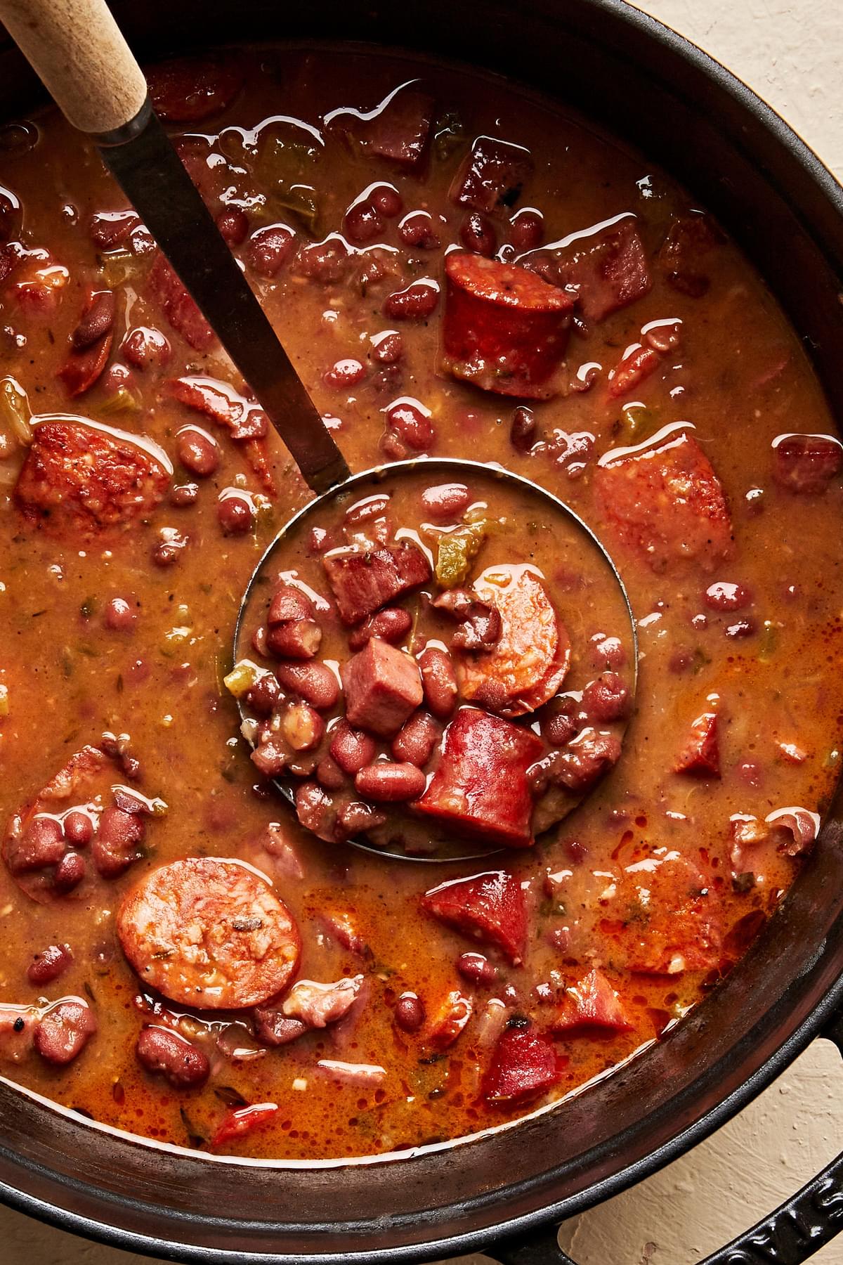 a large pot of homemade Red Beans and Rice with a ladle