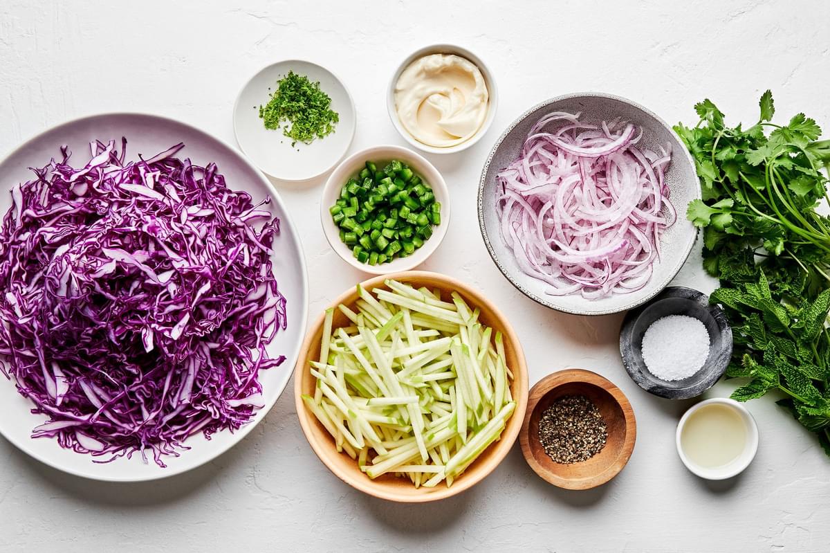 shredded red cabbage, apple, red onion, cilantro, mint, jalapeño, lime zest and juice, mayo, salt and pepper in prep bowls