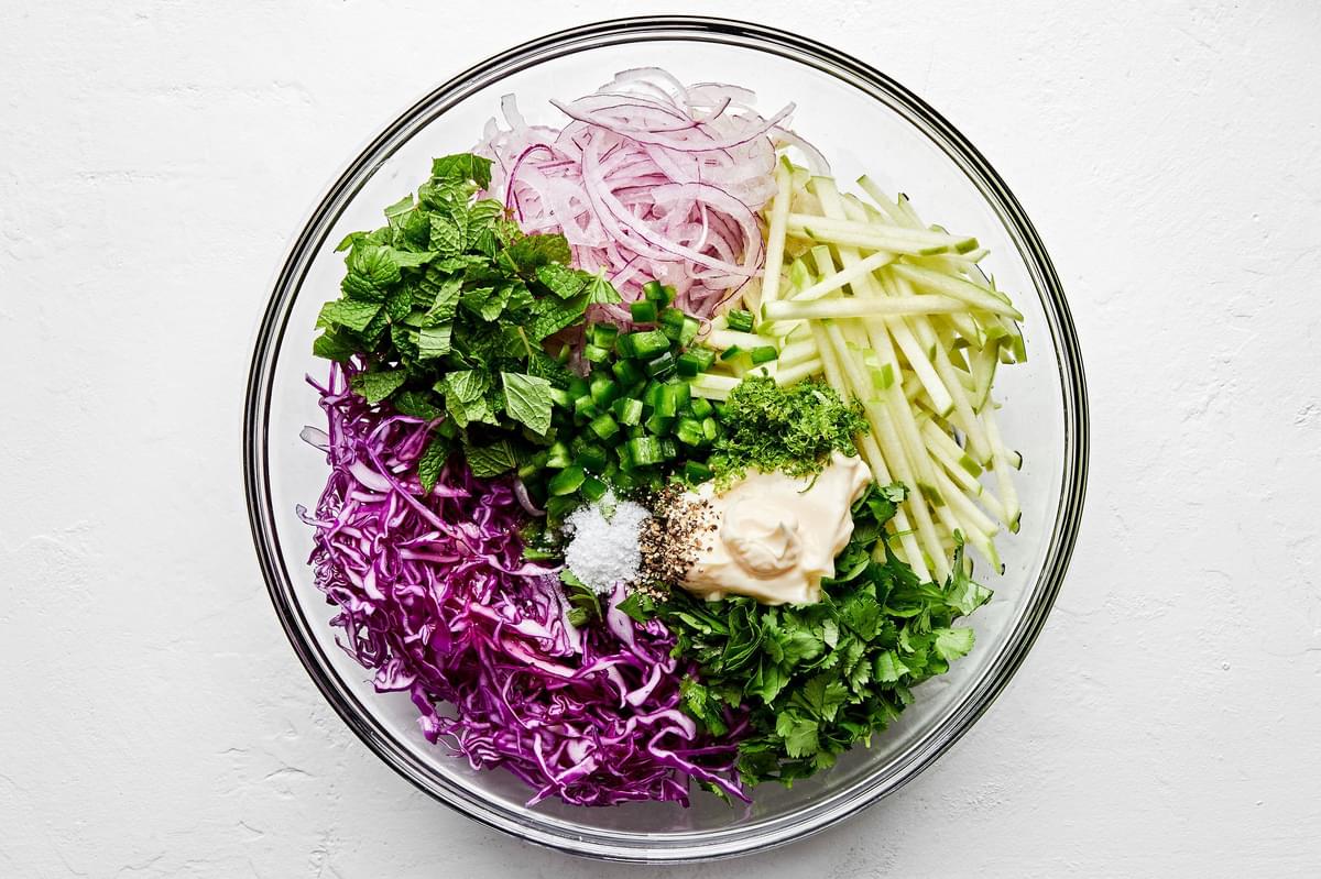 red cabbage, apple, red onion, cilantro, mint, jalapeño, lime zest and juice, mayo, salt and pepper in a large bowl