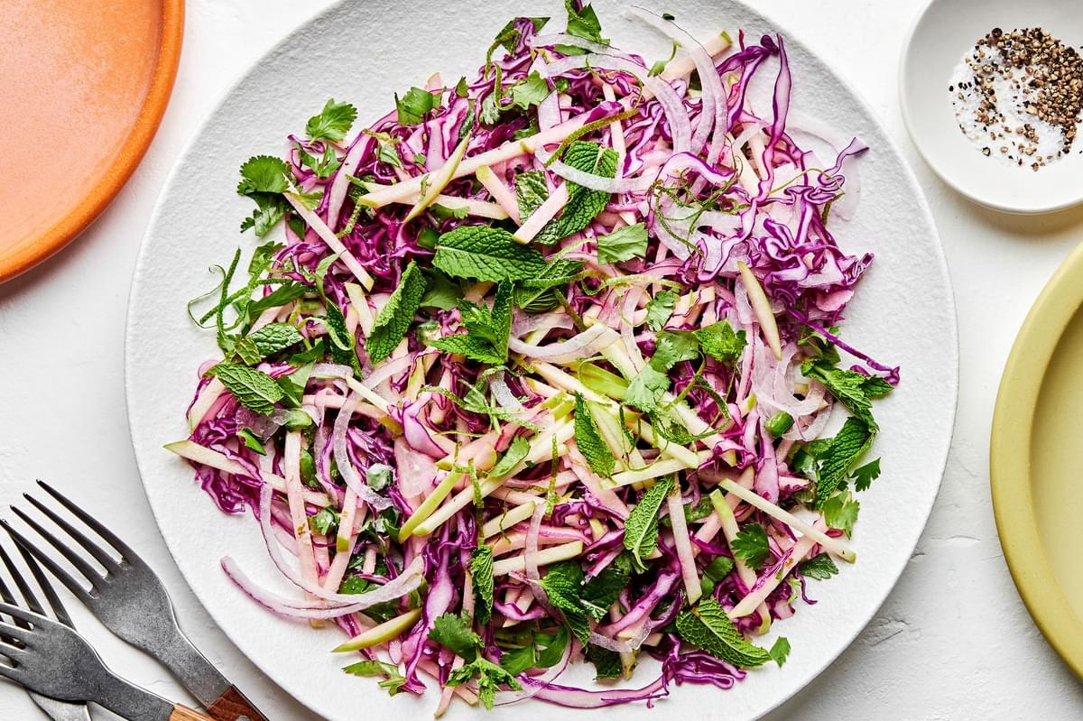 red cabbage and apple slaw made with red onion, cilantro, mint, jalapeño, lime zest and juice, mayo, salt and pepper