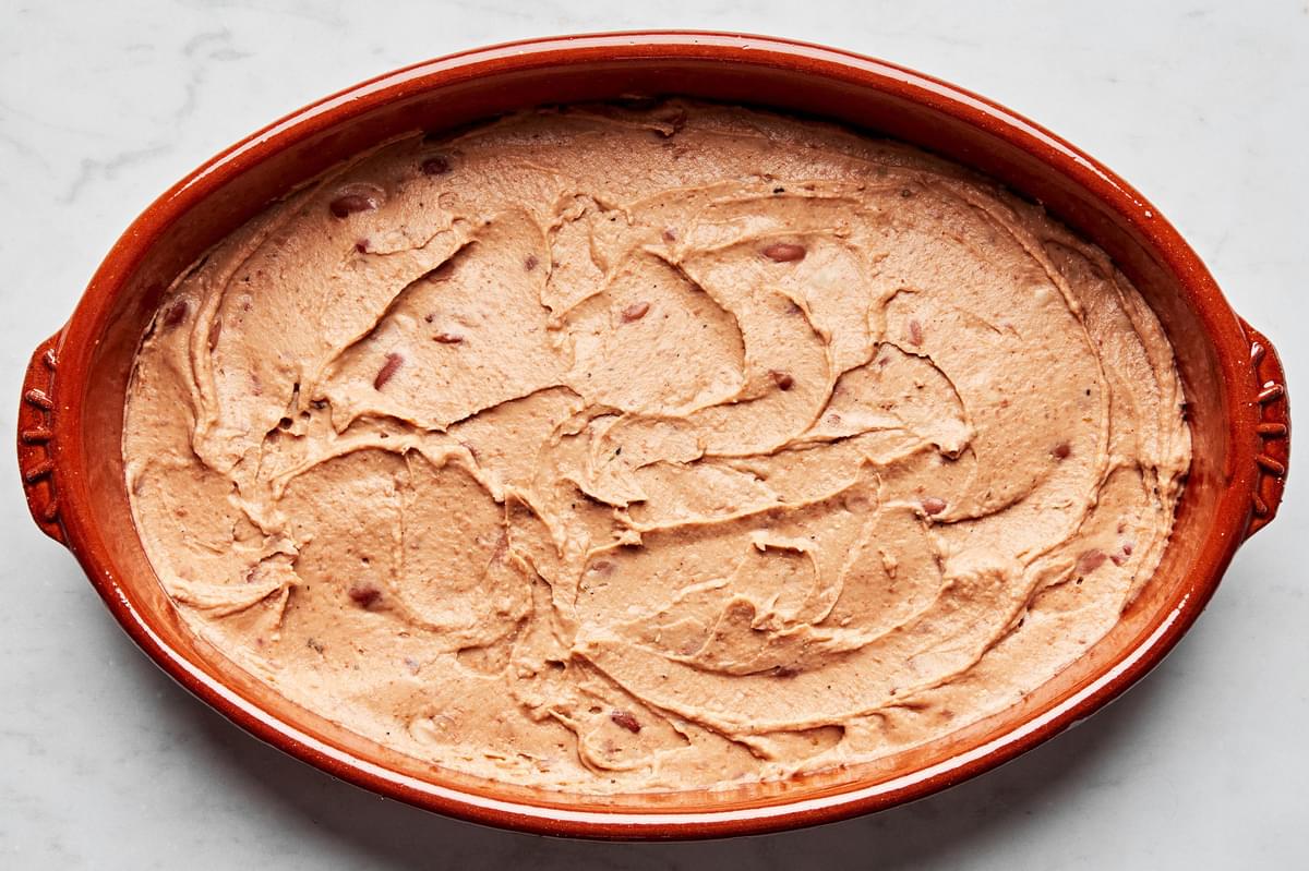 refried beans, taco seasoning and sour cream stirred together and layered on the bottom of a serving bowl