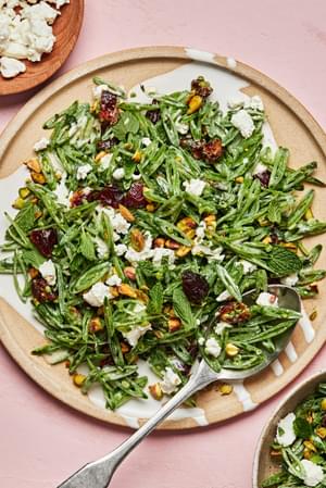 shaved snap pea salad with goat cheese, dates, pistachios and mint tossed with a goat cheese dressing