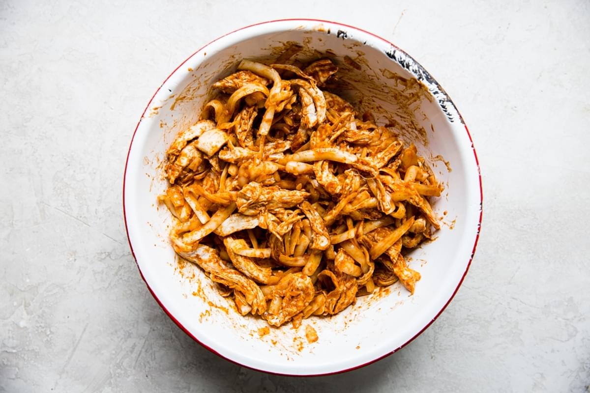 shredded chicken with mole sauce in a bowl