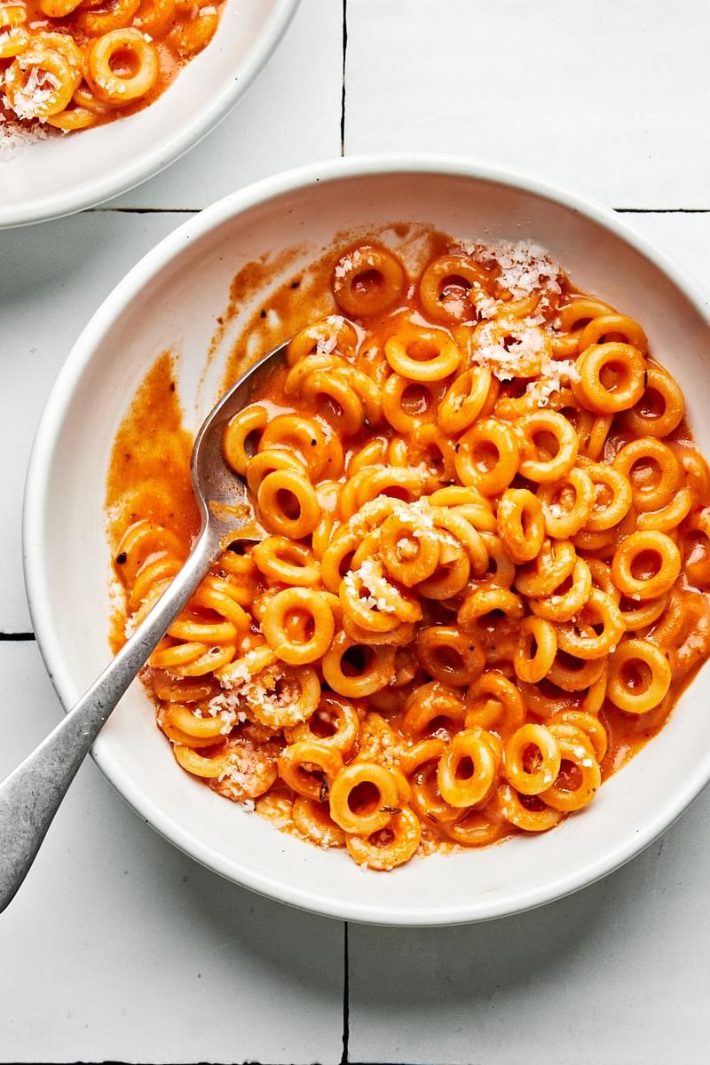 a bowl of homemade spaghettiOs made with tomato paste, butter, spices, tomato sauce, chicken stock, cream and parmesan