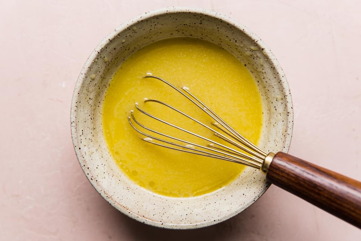 lemon chive vinaigrette in a bowl with a whisk