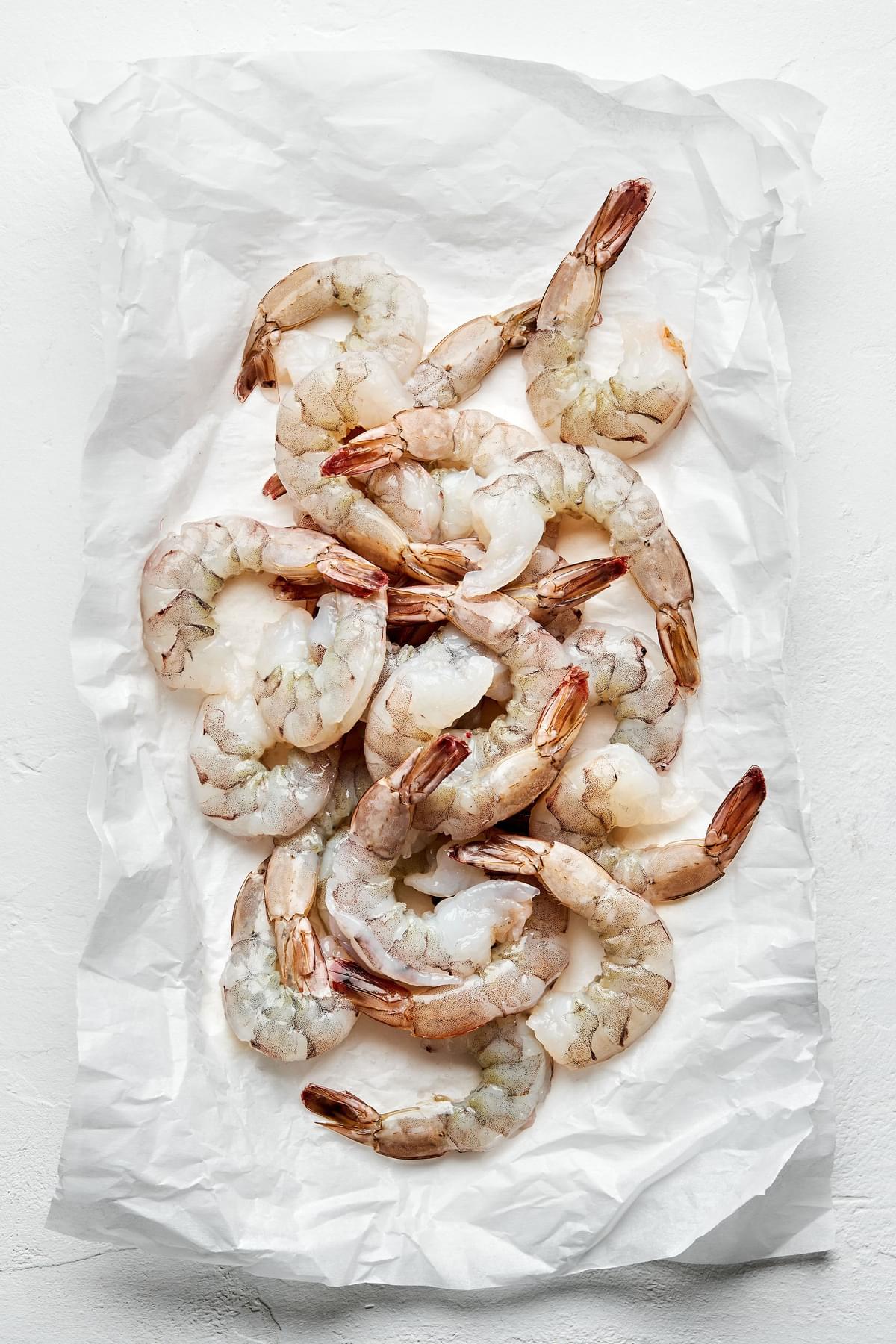 raw shrimp on parchment paper ready to be steamed