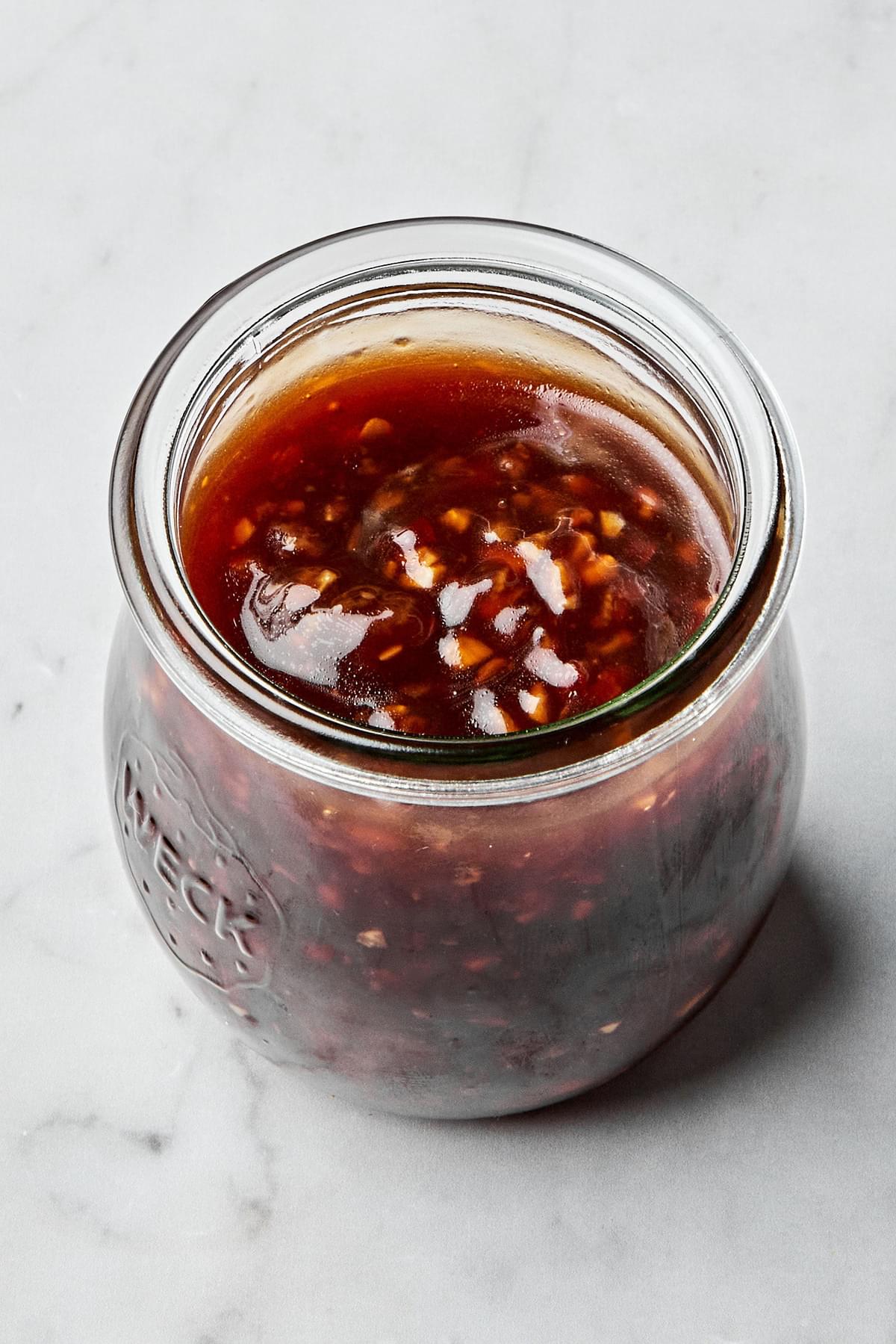 a jar of homemade stir fry sauce made with soy sauce sesame oil garlic, ginger, brown sugar, red pepper flakes and cornstarch
