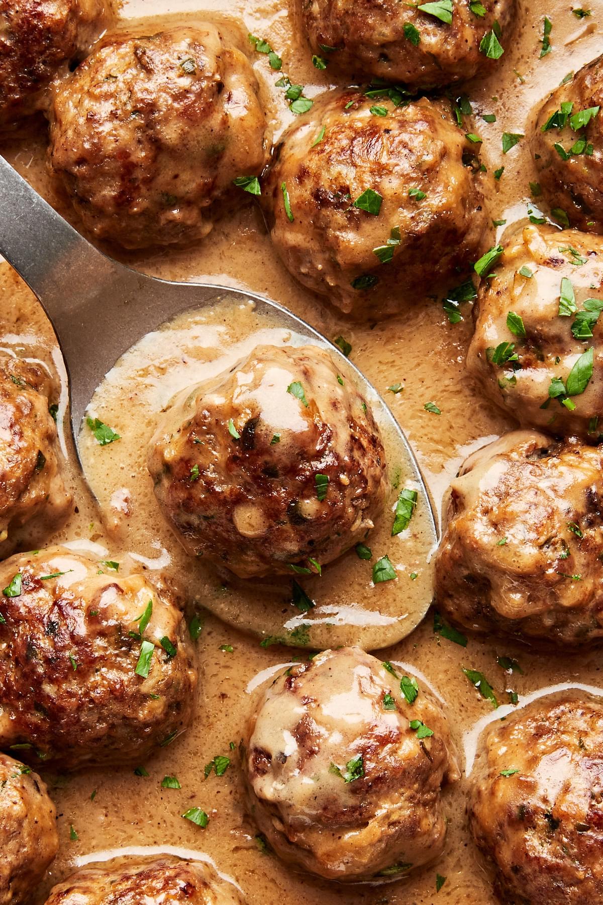 a pan of homemade swedish meatballs made with ground beef and pork in creamy gravy