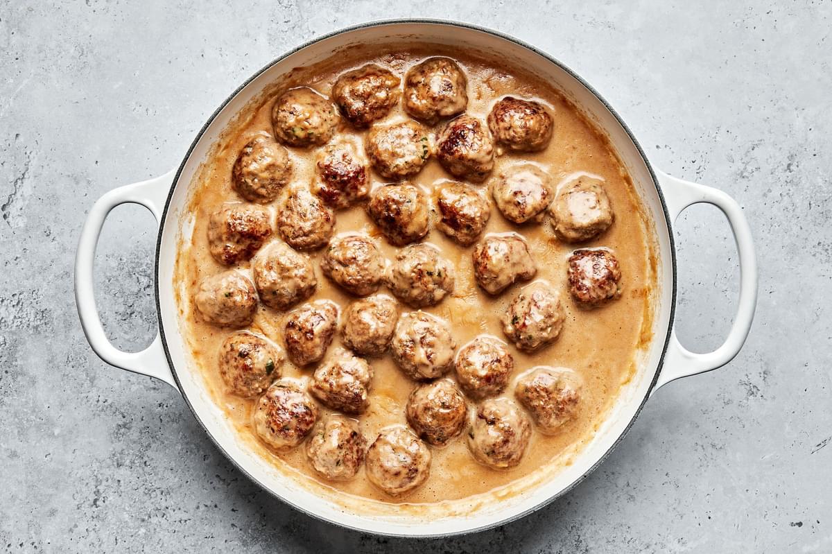 a pan of homemade swedish meatballs made with ground beef and pork in creamy gravy