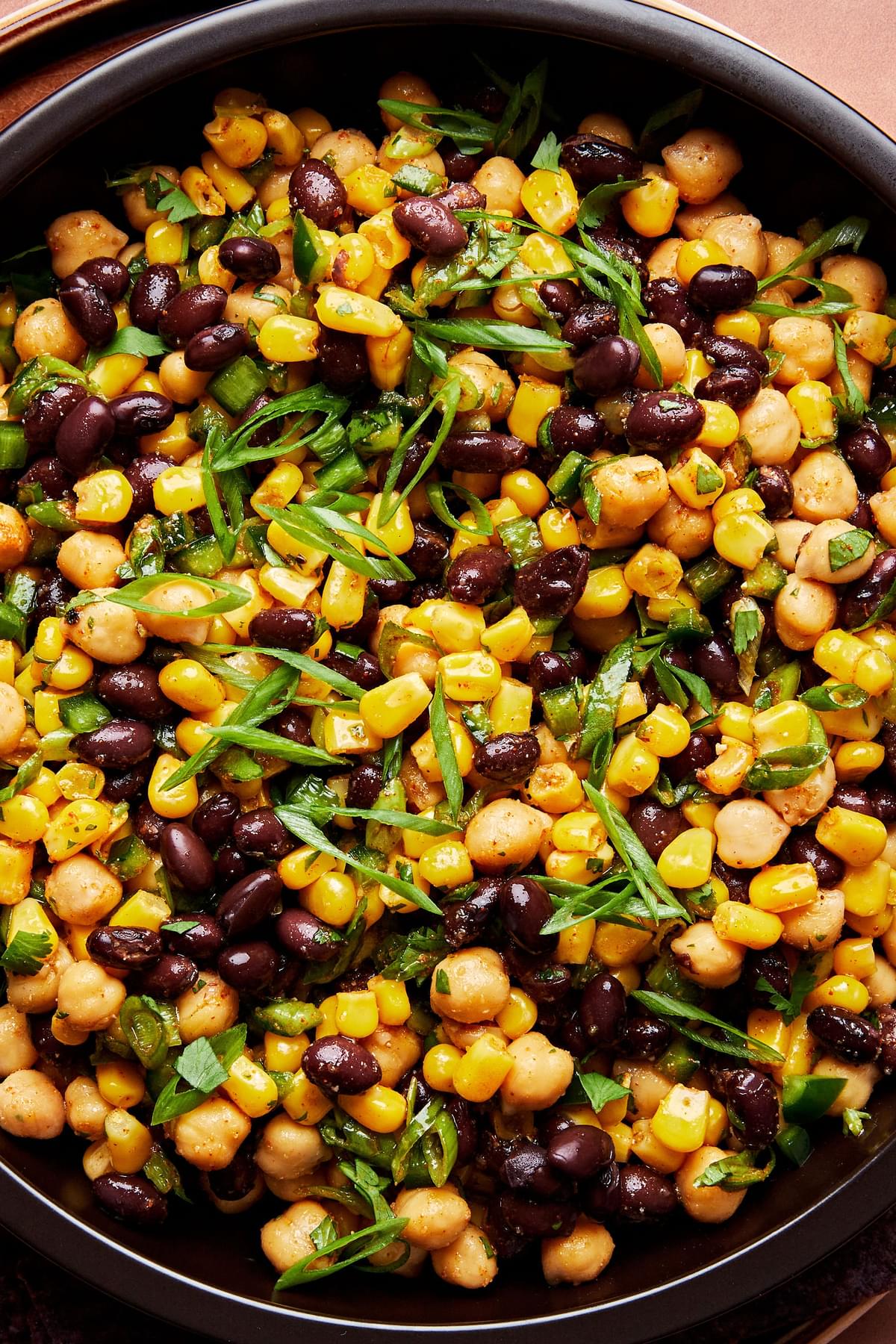 sweet and smoky bean and corn salsa in a bowl made with corn, black beans, chickpeas, Cilantro, Scallions & Poblano pepper