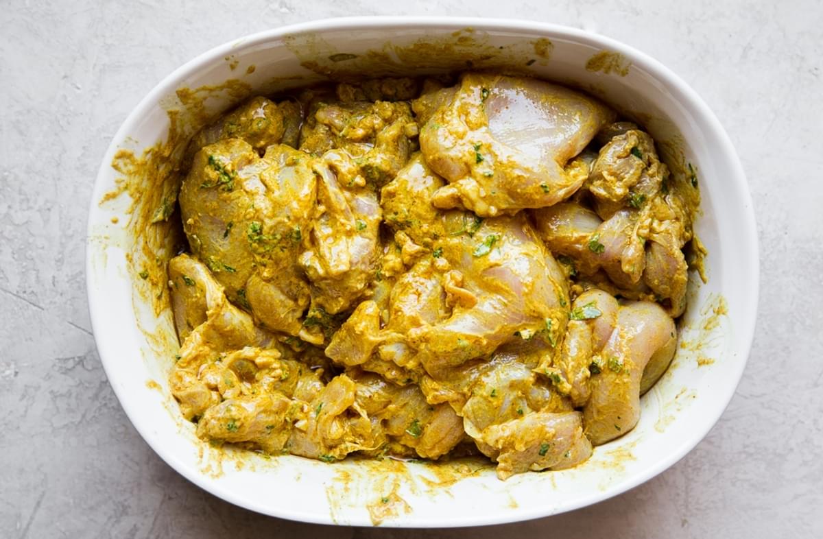 tandoori chicken marinating in a bowl