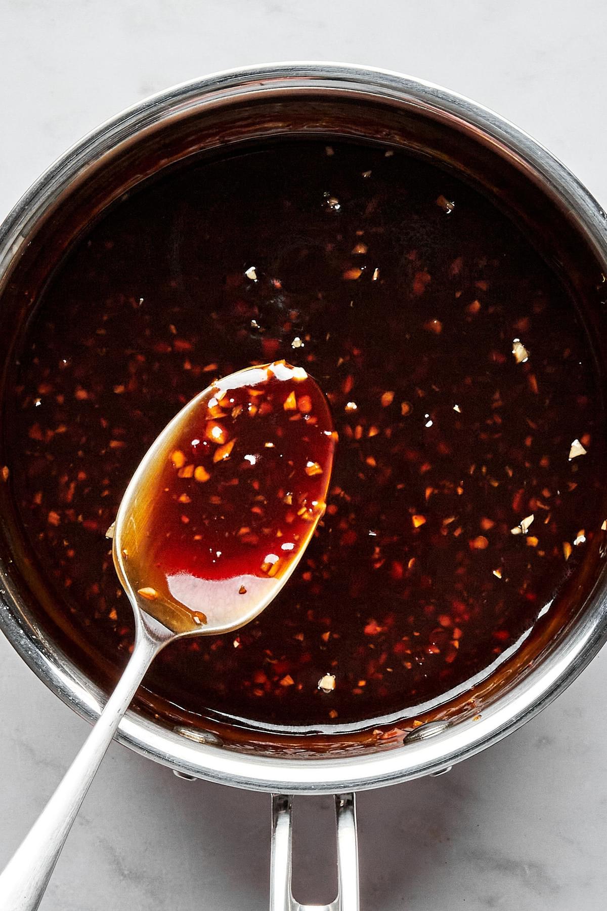 teriyaki sauce in a small sauce pan made with soy sauce, brown sugar, garlic, ginger, lime juice, sesame oil and chili paste