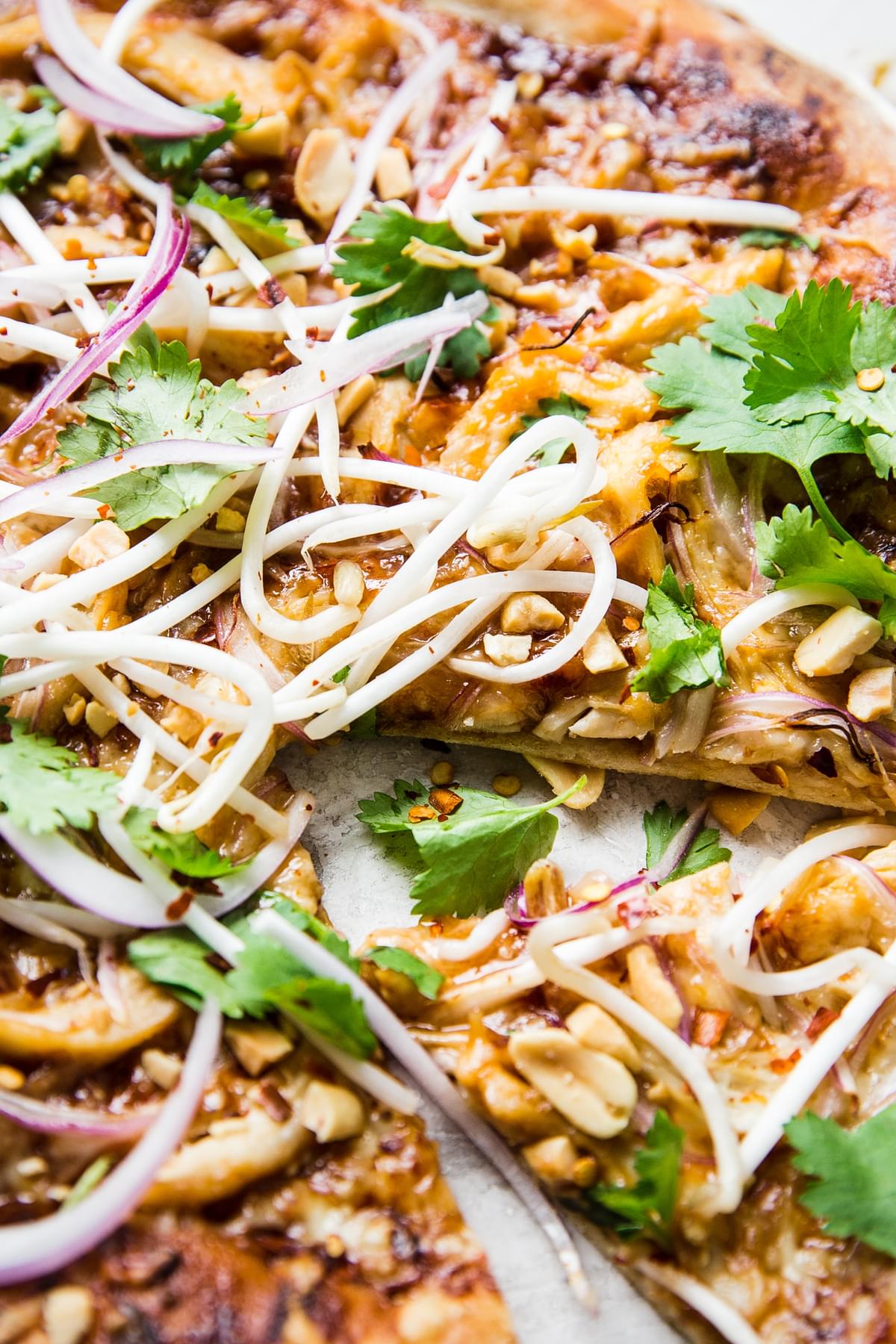 Thai pizza with peanut sauce chicken, hoisin sauce, red onions and cilantro