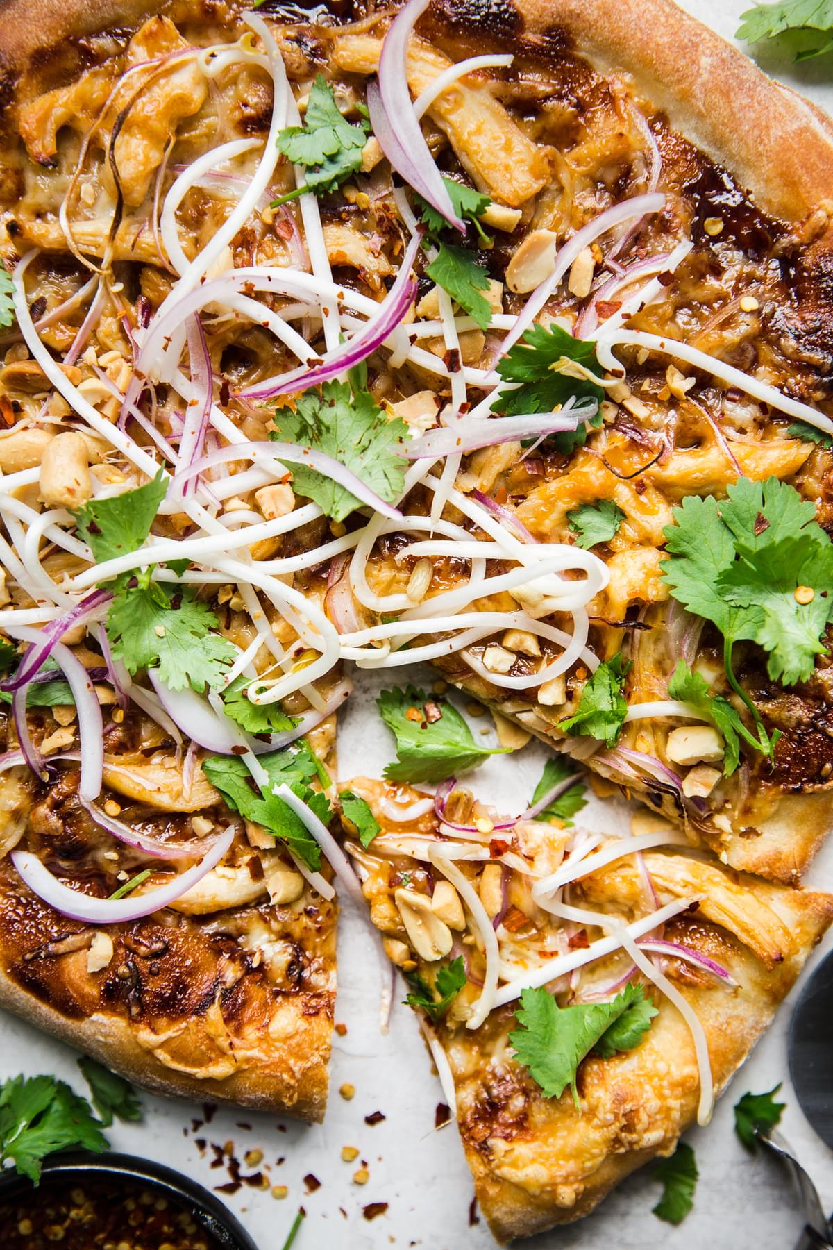 Thai pizza with peanut sauce chicken, hoisin sauce, red onions and cilantro
